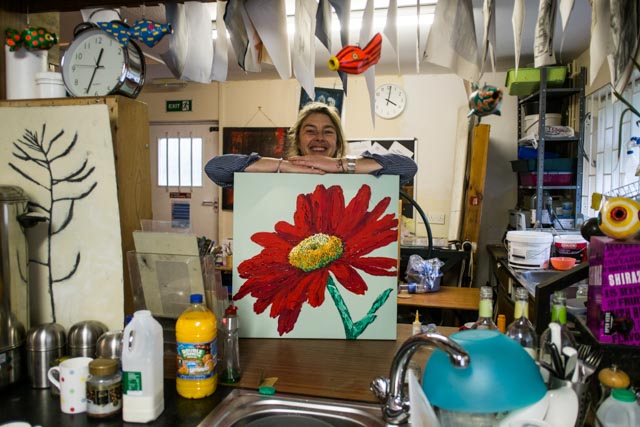 A happy artist with their work in the studio